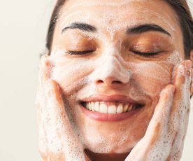 Beautiful woman washing her face