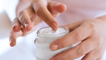 woman's hand touching on the cream for applying