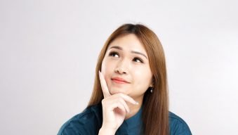 woman-is-sitting-table-is-looking-up-wearing-blue-shirt
